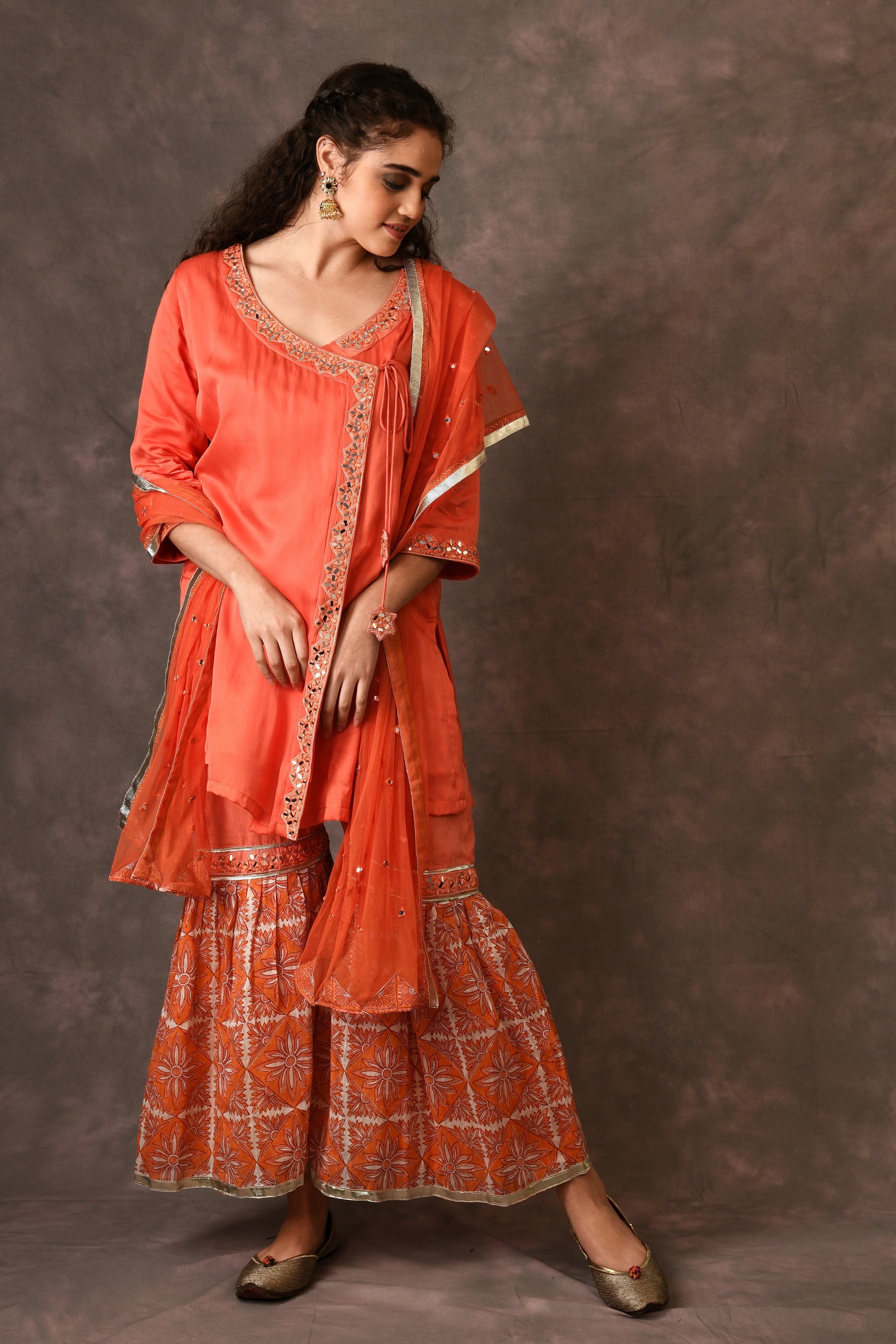 Orange Flame Angarkha And Sharara Set With Mirror Embroidery And Handblock Printed Temple Flower Moti